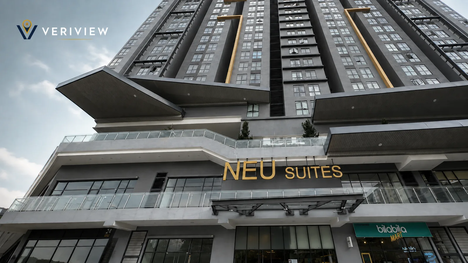 Fasad menara Neu Suites Residence di Ampang, Kuala Lumpur, dengan papan nama NEU SUITES berwarna emas